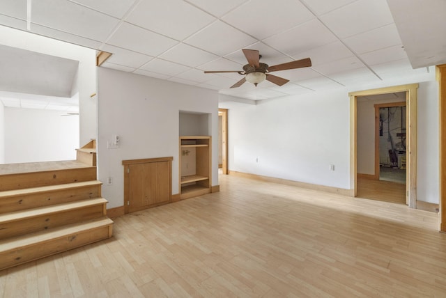 unfurnished living room featuring a paneled ceiling, light wood-type flooring, and ceiling fan