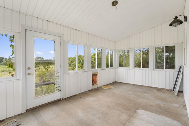 unfurnished sunroom featuring vaulted ceiling