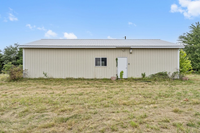 view of outbuilding with a lawn