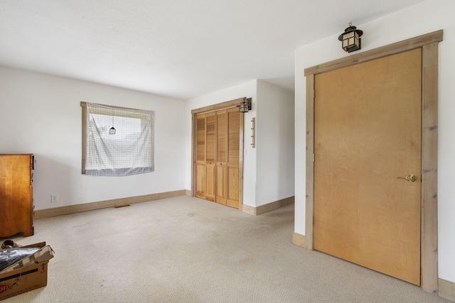 unfurnished bedroom featuring a closet and light carpet