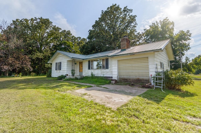 ranch-style house with a garage and a front yard