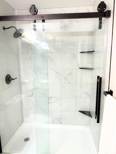 bathroom with a shower with shower door