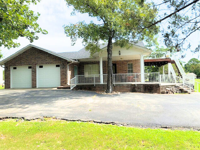 view of front of home with a porch and a garage