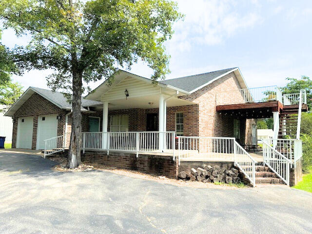 view of front of property with a porch and a garage