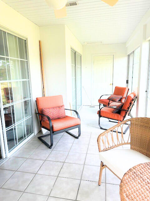 sunroom / solarium featuring plenty of natural light and wood ceiling