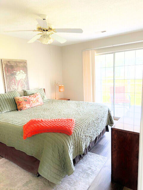 bedroom with ceiling fan and hardwood / wood-style floors