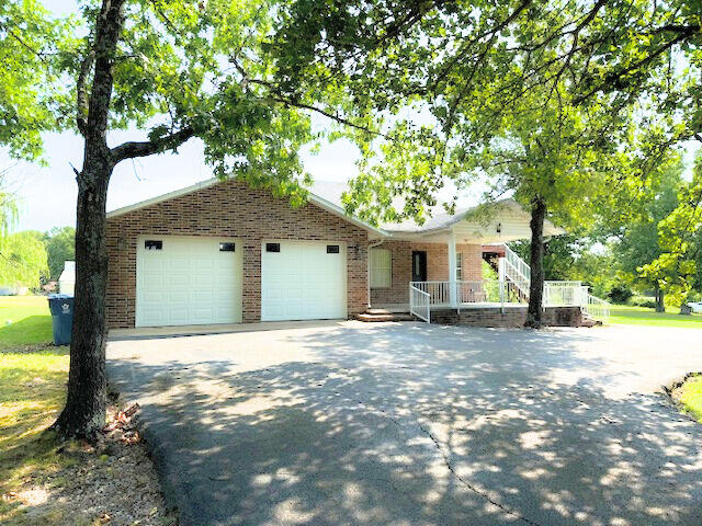 ranch-style house with a garage and a porch