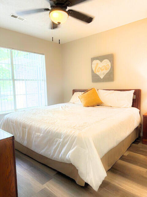 bedroom featuring ceiling fan and wood-type flooring