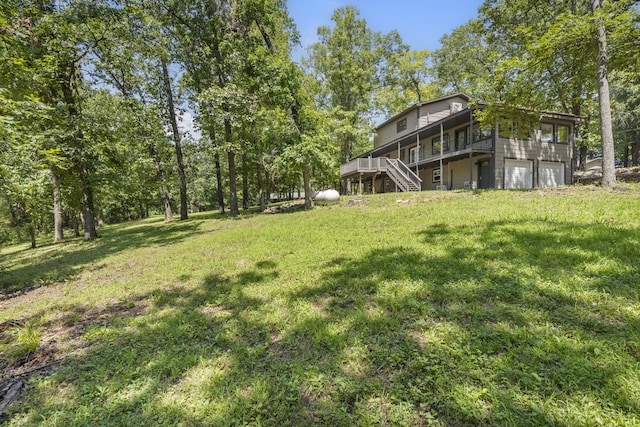 view of yard with a garage and a deck