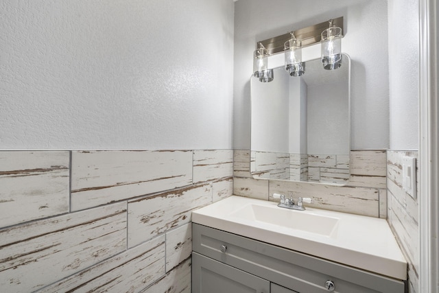 bathroom with tile walls and vanity