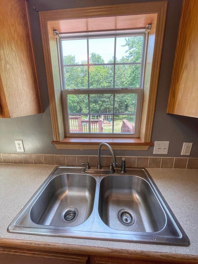 room details featuring sink and decorative backsplash