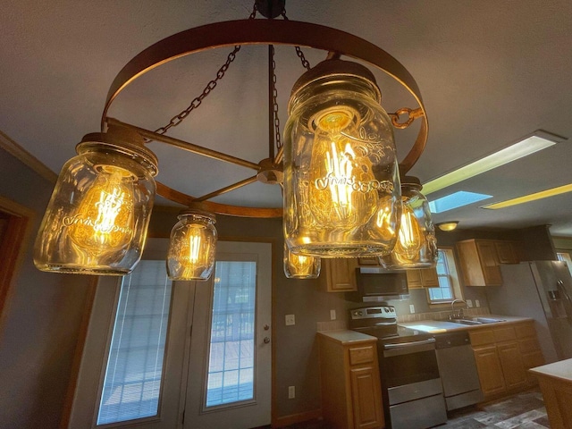 kitchen featuring light brown cabinetry, sink, and white appliances