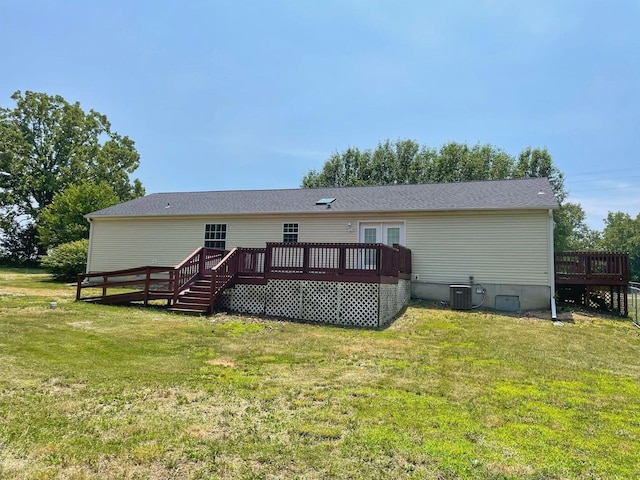 back of house with a wooden deck, a lawn, and central AC unit