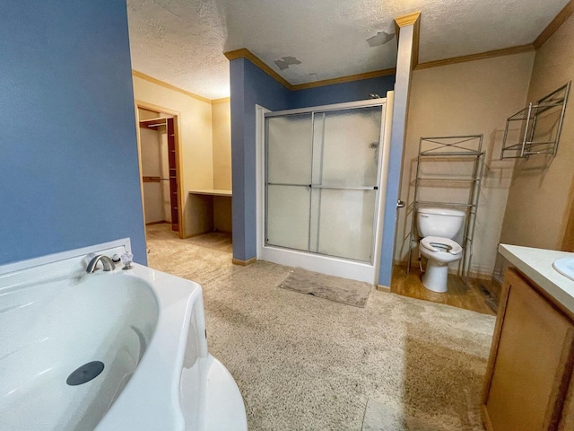 bathroom featuring a shower stall, toilet, vanity, crown molding, and a garden tub