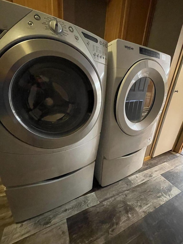 washroom with washing machine and clothes dryer and cabinet space