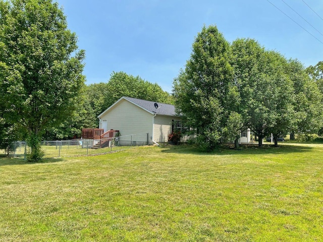 view of yard featuring fence and a deck