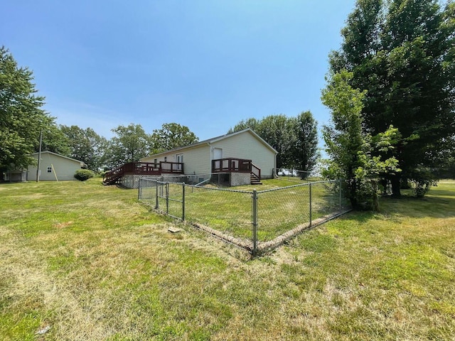 view of yard featuring fence, a wooden deck, and stairway