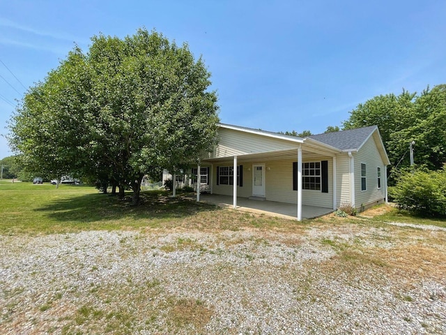 view of front of property with a carport and a patio area