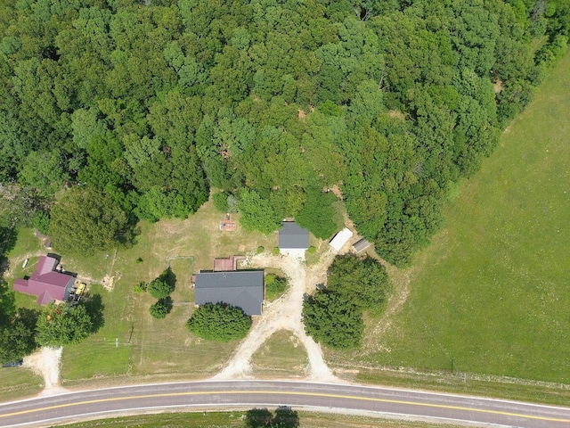 drone / aerial view featuring a view of trees