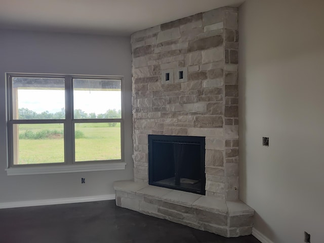 interior details with a fireplace and concrete floors