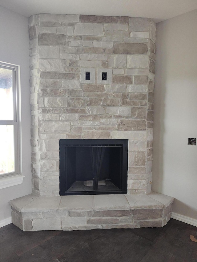 interior details featuring a fireplace and wood-type flooring