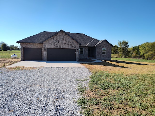 view of front of house featuring a garage and a front lawn