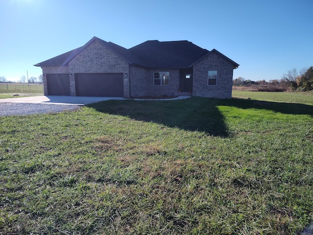 view of front of property featuring a garage and a front lawn