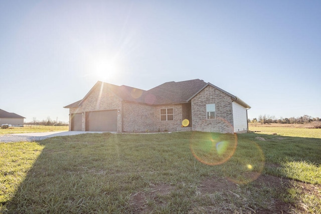 view of front of house featuring a garage and a front lawn