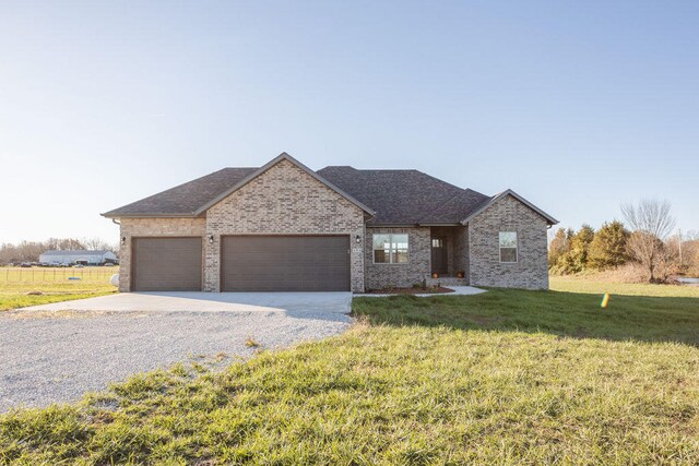 view of front facade with a front yard and a garage