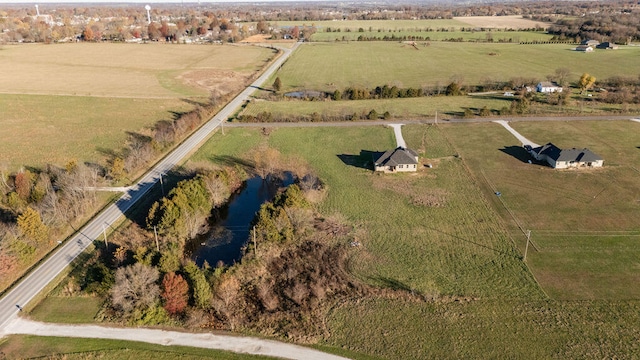 drone / aerial view featuring a rural view and a water view