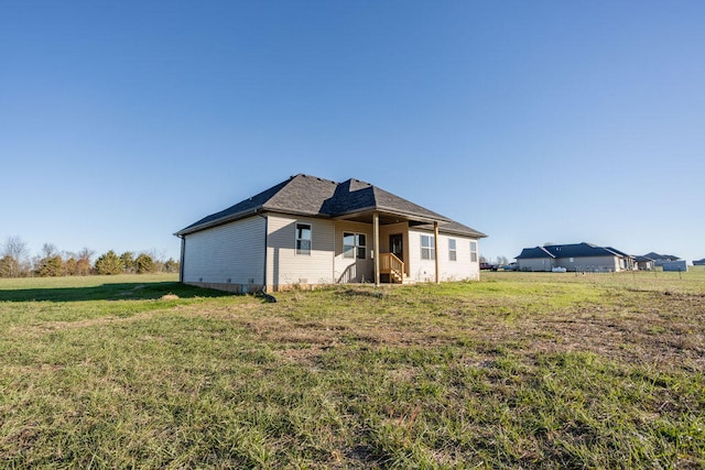 rear view of house with a yard