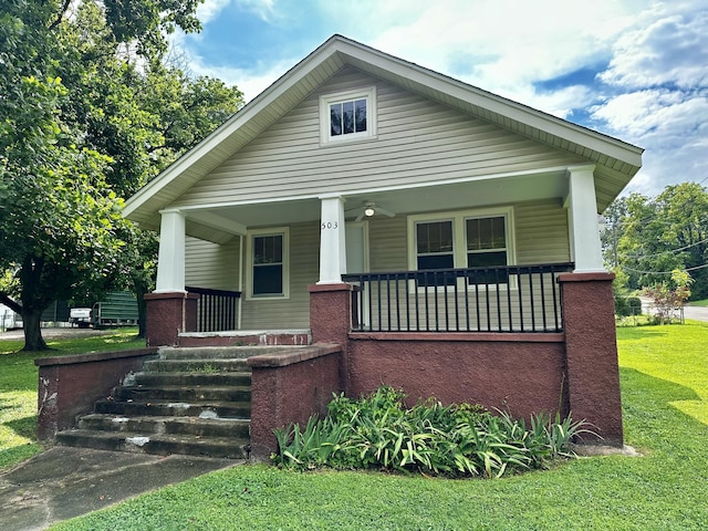bungalow-style house featuring a front lawn and covered porch