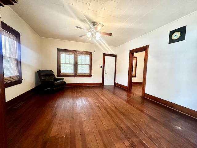 sitting room featuring visible vents, baseboards, dark wood-type flooring, and ceiling fan