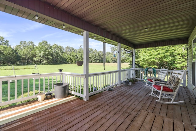 wooden deck with a yard and covered porch