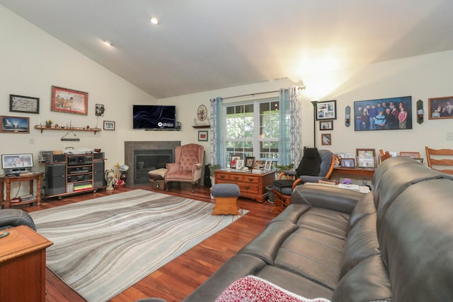 living room with hardwood / wood-style floors and lofted ceiling