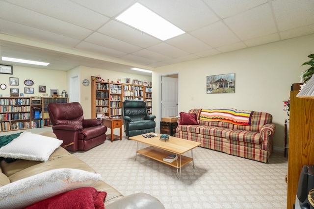 living room featuring a paneled ceiling and light carpet