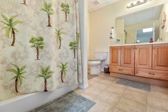 full bathroom featuring toilet, vanity, tile patterned floors, and shower / bathtub combination with curtain