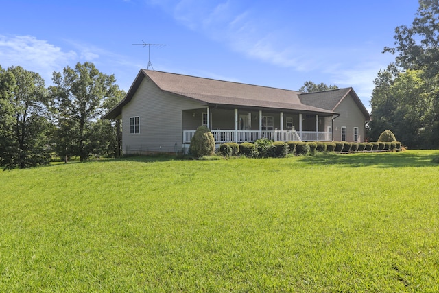 back of property featuring a yard and a porch