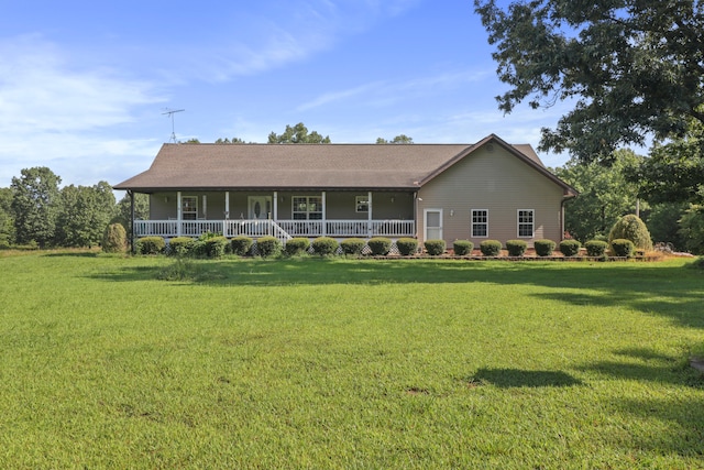 rear view of house with a lawn and a porch