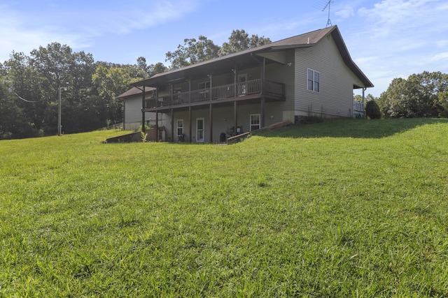 back of property featuring a deck and a yard