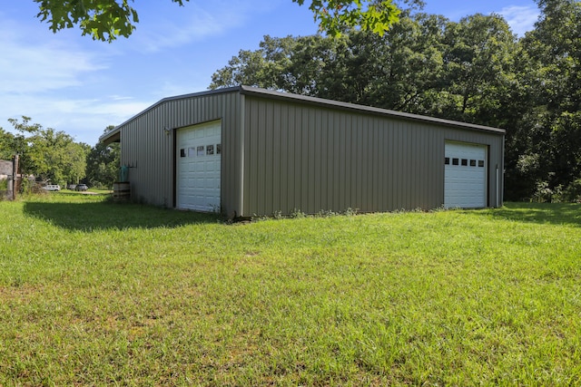 garage featuring a lawn