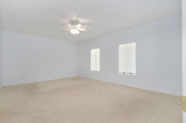 empty room featuring light carpet and ceiling fan