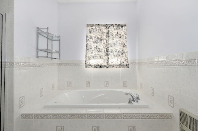 bathroom featuring tiled bath