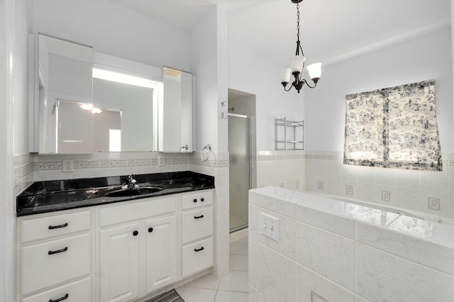 bathroom featuring vanity, a notable chandelier, a shower with door, and tile patterned floors