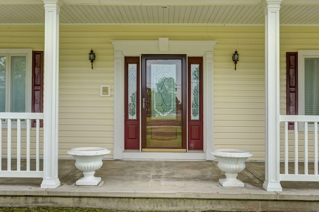 view of exterior entry with covered porch