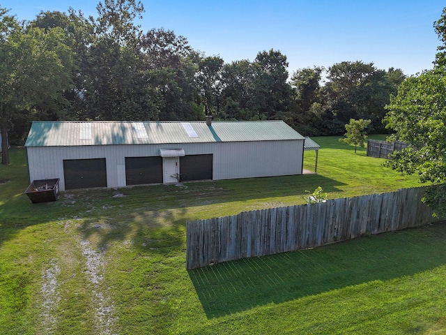 view of outbuilding featuring a garage and a lawn