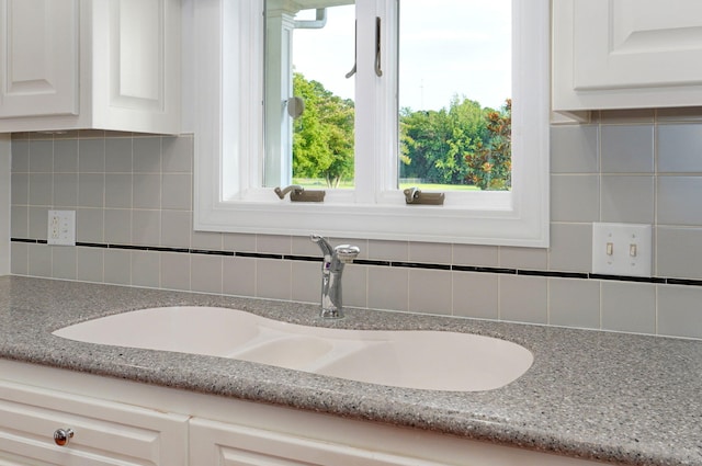 interior details with decorative backsplash and sink