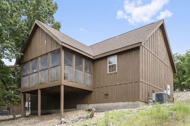 back of house with a sunroom and central AC unit