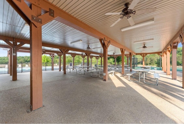 view of community with a water view and a patio area