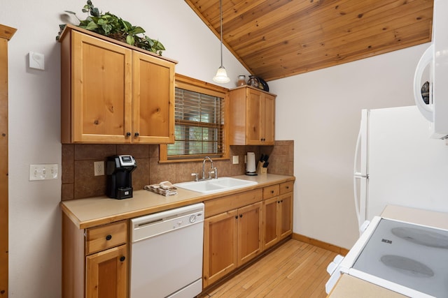 kitchen with lofted ceiling, hanging light fixtures, sink, white appliances, and decorative backsplash